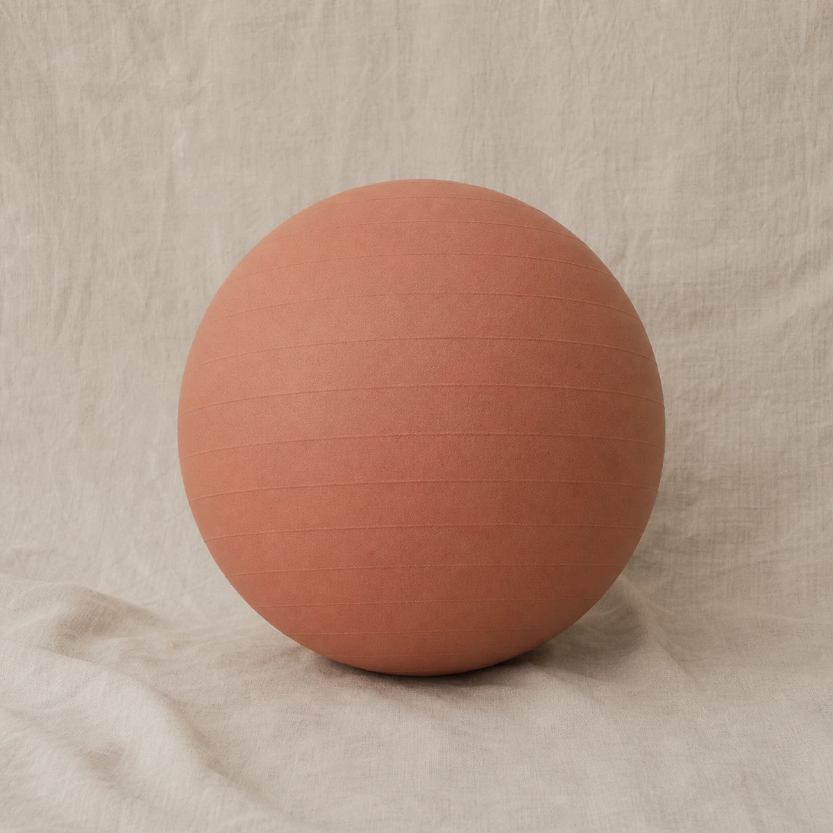 Terra Grounding Ball in muted clay on a linen backdrop